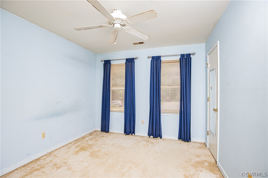 12137 Quito Road Midlothian, VA 23112 - Photo 19 of 34 a view of a big room with windows and chandelier fan