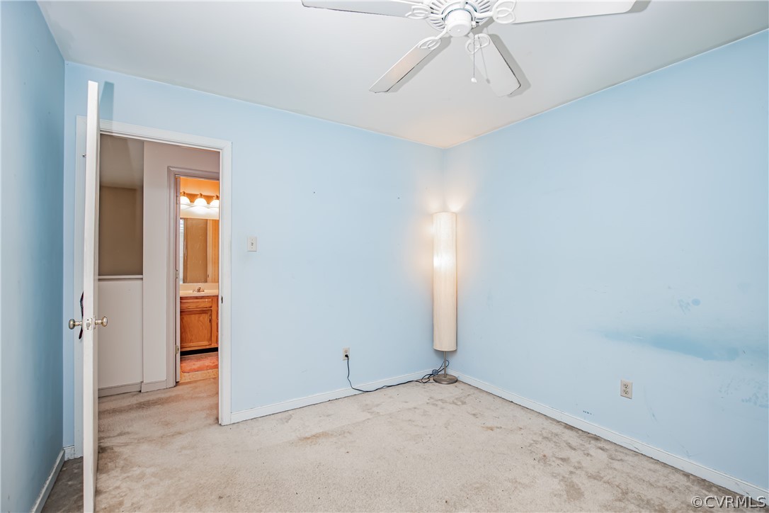 12137 Quito Road Midlothian, VA 23112 - Photo 20 of 34 an empty room with a ceiling fan and carpet