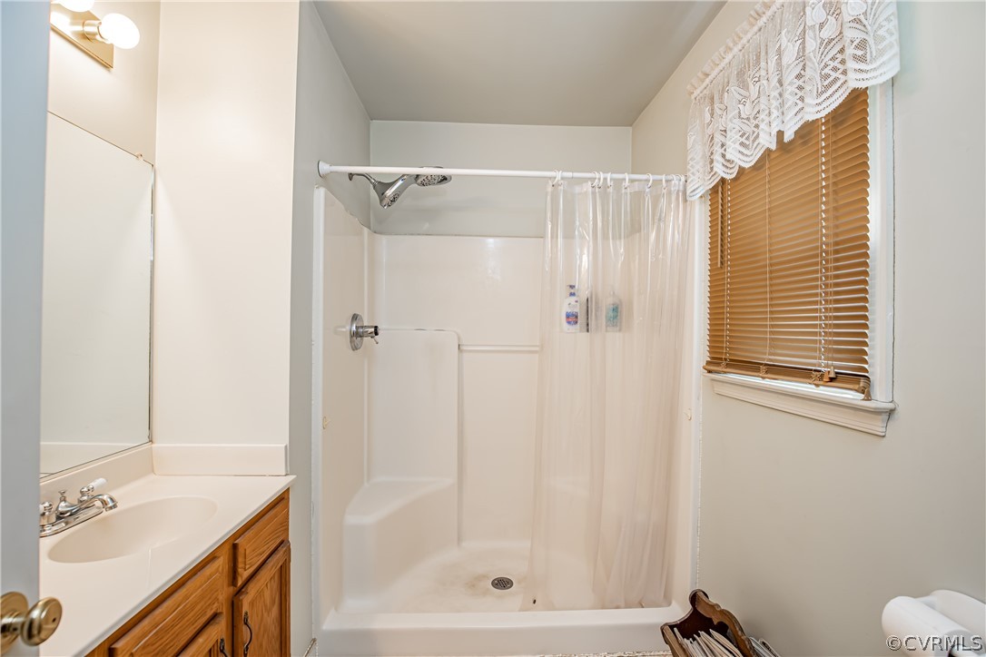 12137 Quito Road Midlothian, VA 23112 - Photo 24 of 34 a bathroom with a shower curtain and a sink