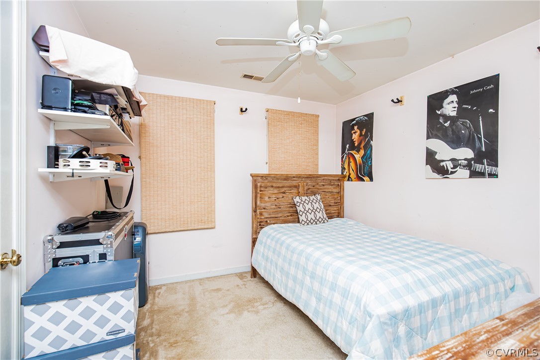 12137 Quito Road Midlothian, VA 23112 - Photo 25 of 34 a bedroom with a bed and a chandelier