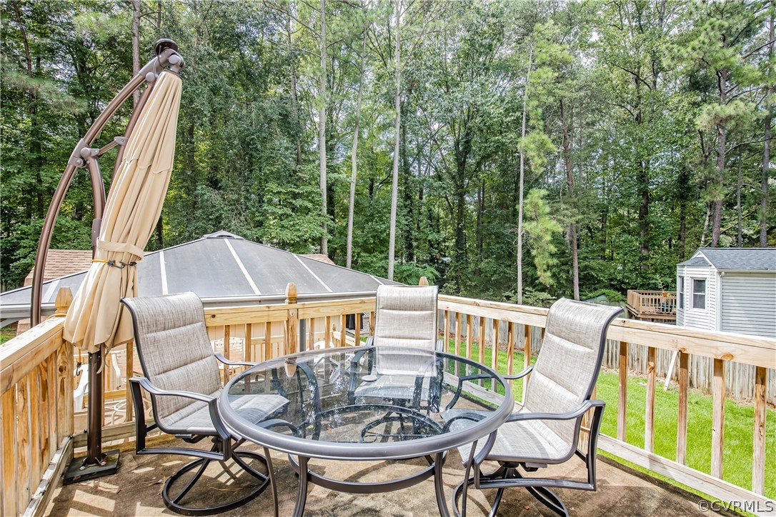 12137 Quito Road Midlothian, VA 23112 - Photo 29 of 34 a view of a patio with table and chairs and wooden floor