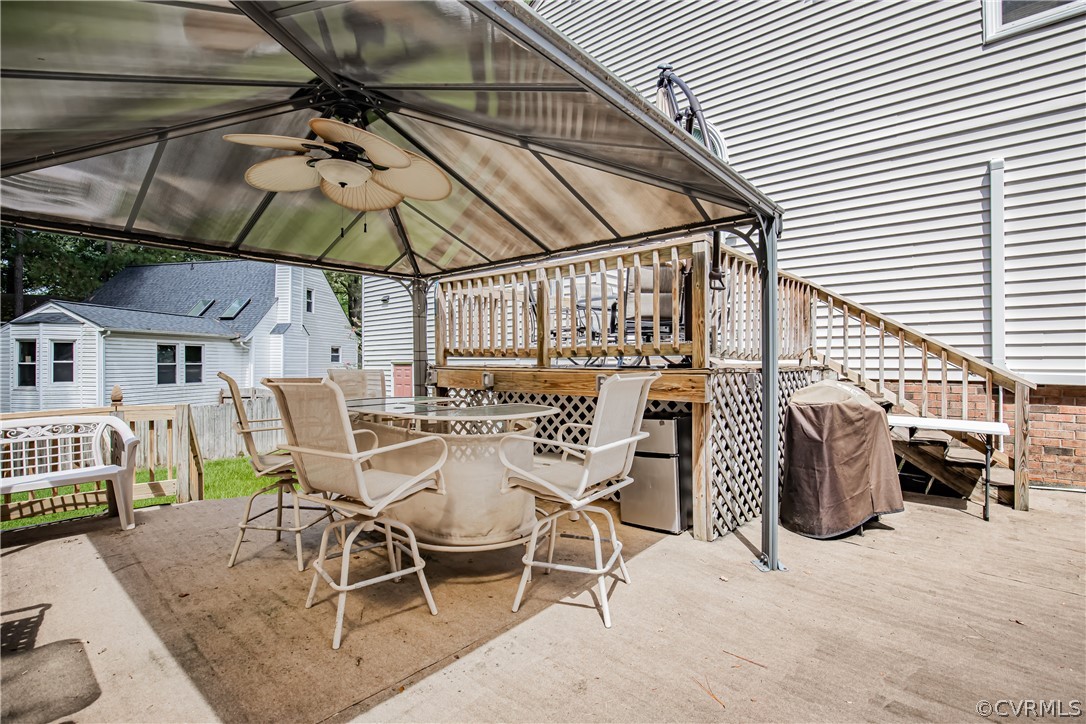 12137 Quito Road Midlothian, VA 23112 - Photo 30 of 34 a view of a patio with table and chairs under an umbrella