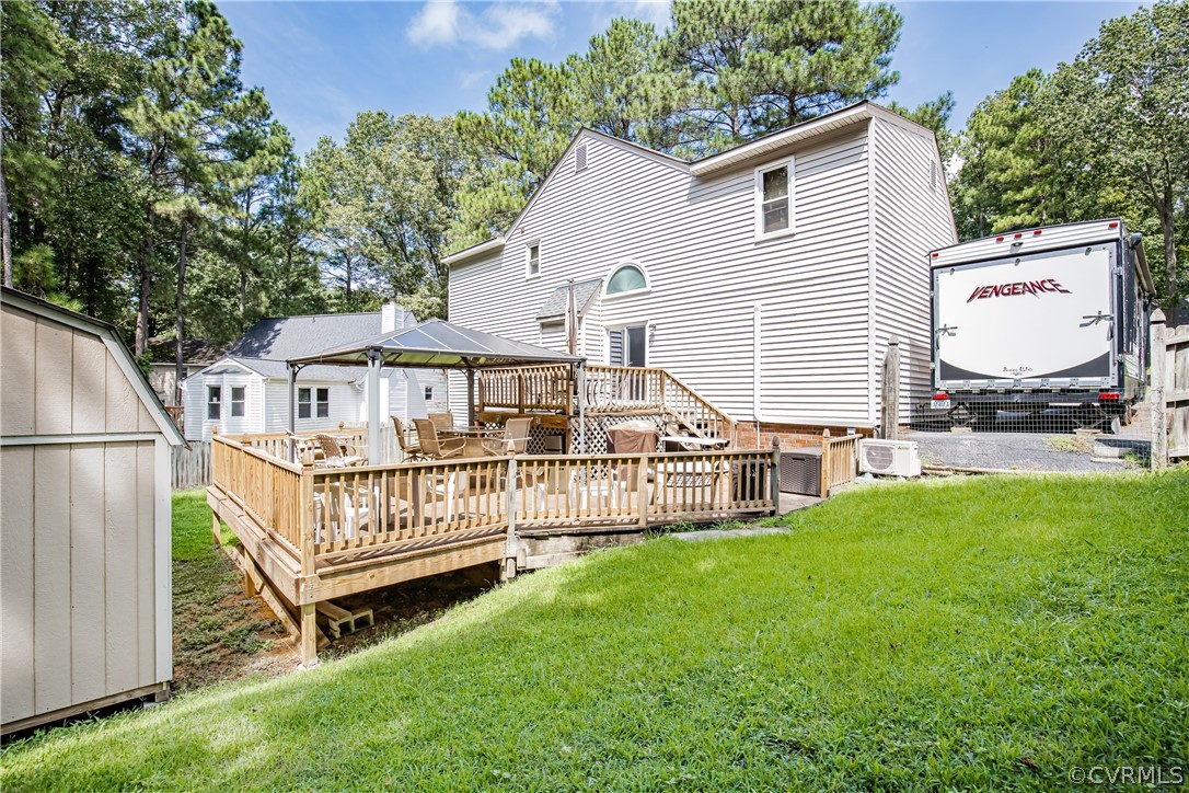 12137 Quito Road Midlothian, VA 23112 - Photo 34 of 34 a view of a house with a yard and deck