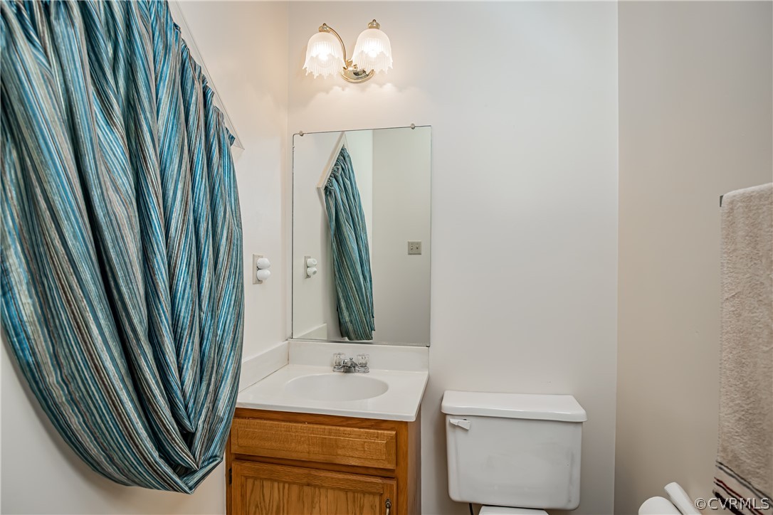 12137 Quito Road Midlothian, VA 23112 - Photo 6 of 34 a bathroom with a sink a toilet and a mirror