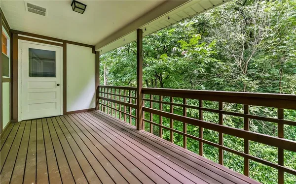 a view of balcony with wooden floor