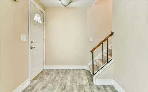a view of an entryway with wooden floor