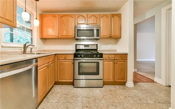 a kitchen with a stove and a microwave