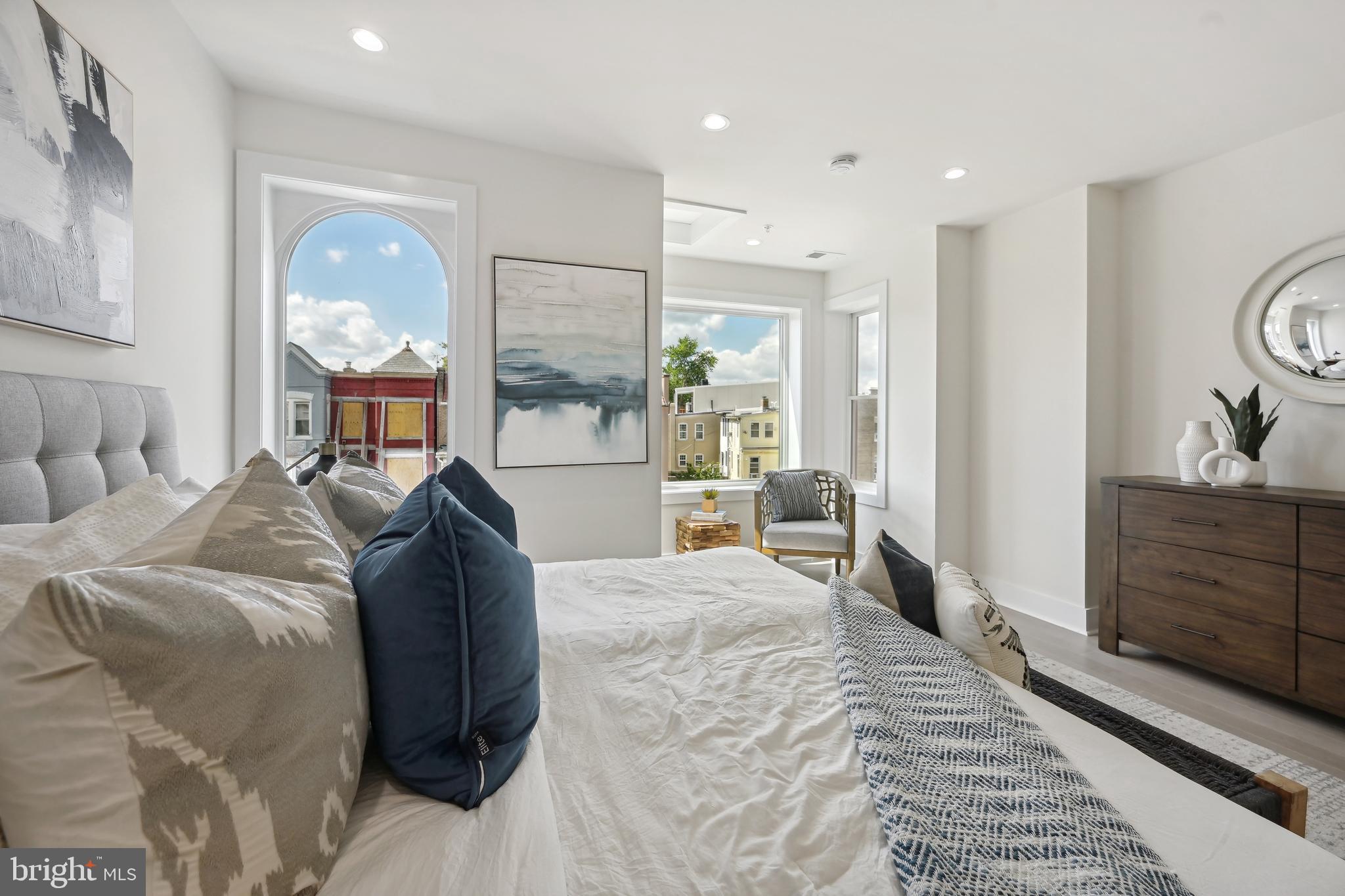 3657 13th Street Northwest Washington, DC 20010 - Photo 12 of 35 a bed room with a bed a mirror on dresser and a window