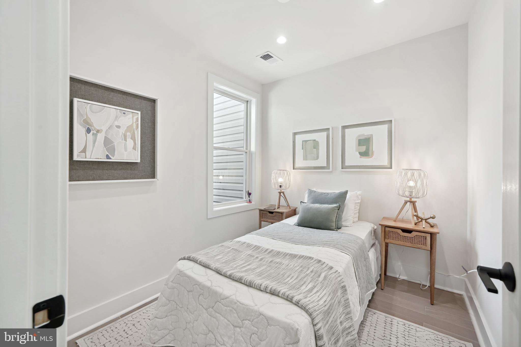3657 13th Street Northwest Washington, DC 20010 - Photo 15 of 35 a bedroom with a bed and a window