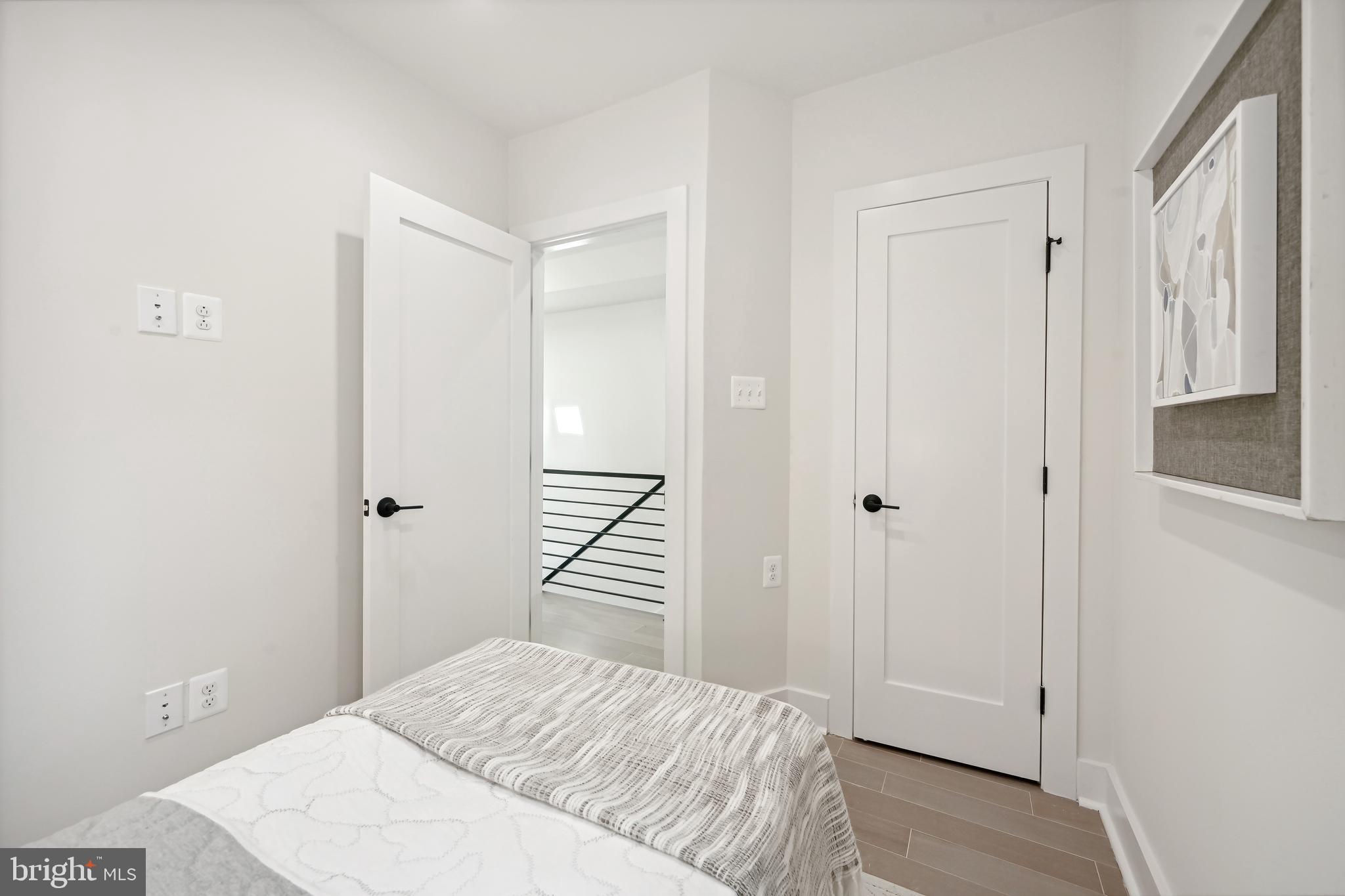 3657 13th Street Northwest Washington, DC 20010 - Photo 16 of 35 a bedroom with a bed and wooden floor