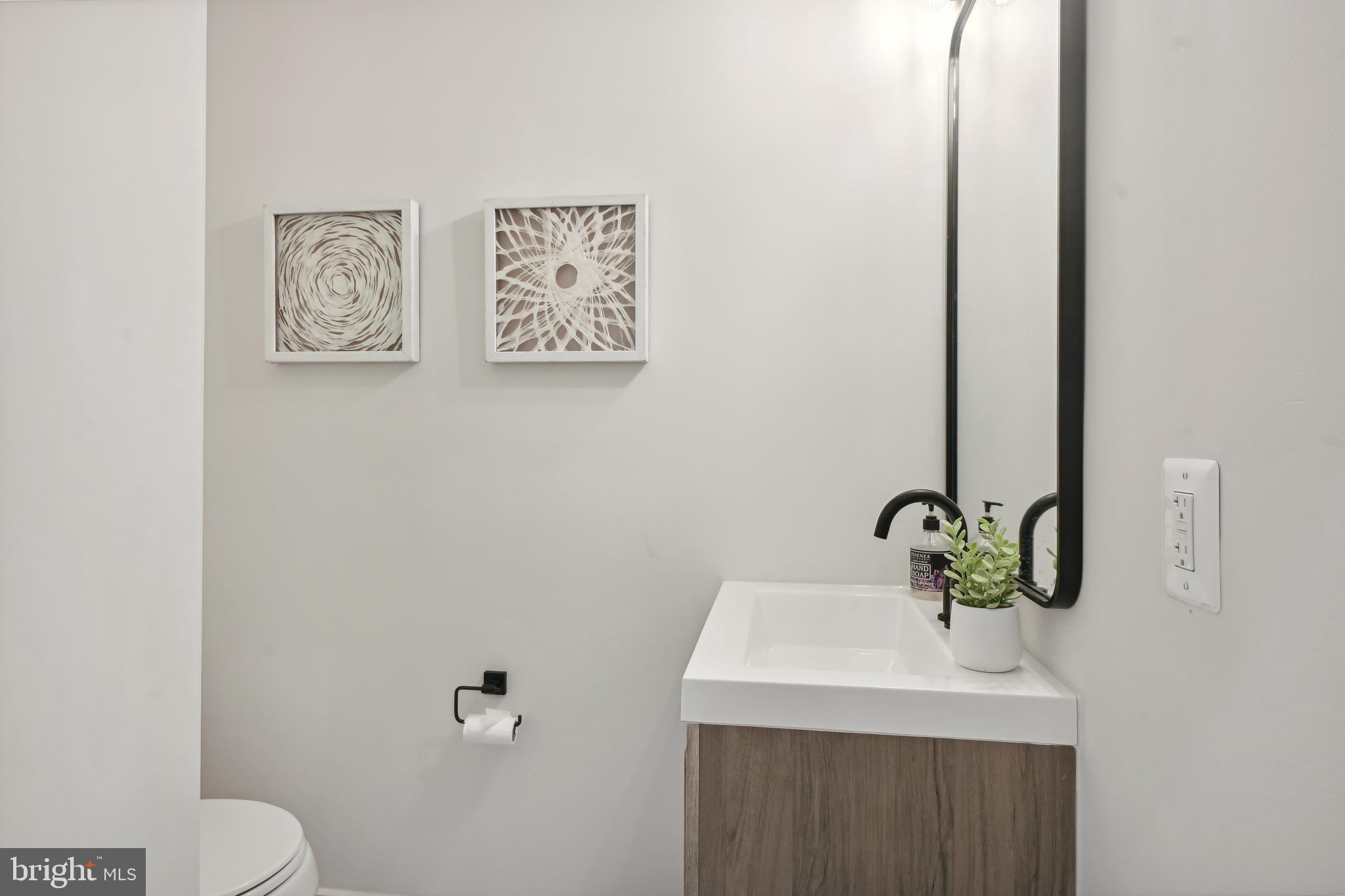 3657 13th Street Northwest Washington, DC 20010 - Photo 18 of 35 a bathroom with a sink mirror and toilet