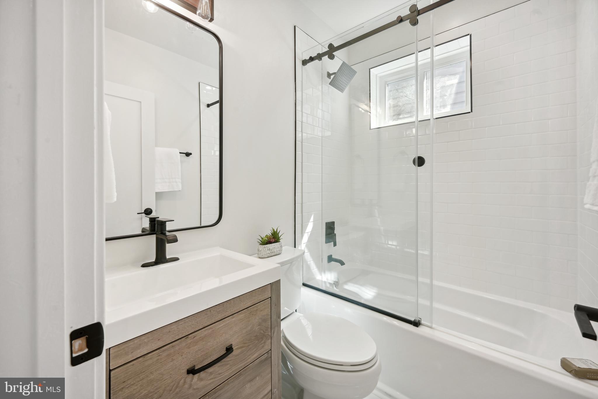 3657 13th Street Northwest Washington, DC 20010 - Photo 19 of 35 a bathroom with a sink a toilet and shower