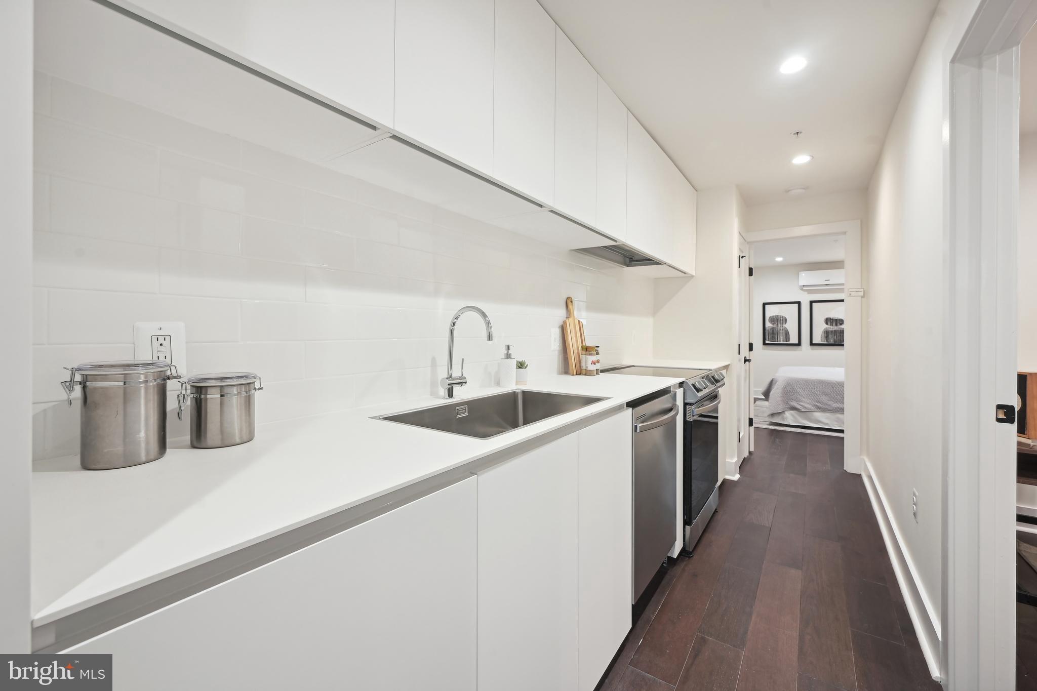 3657 13th Street Northwest Washington, DC 20010 - Photo 24 of 35 a kitchen with sink a stove and refrigerator