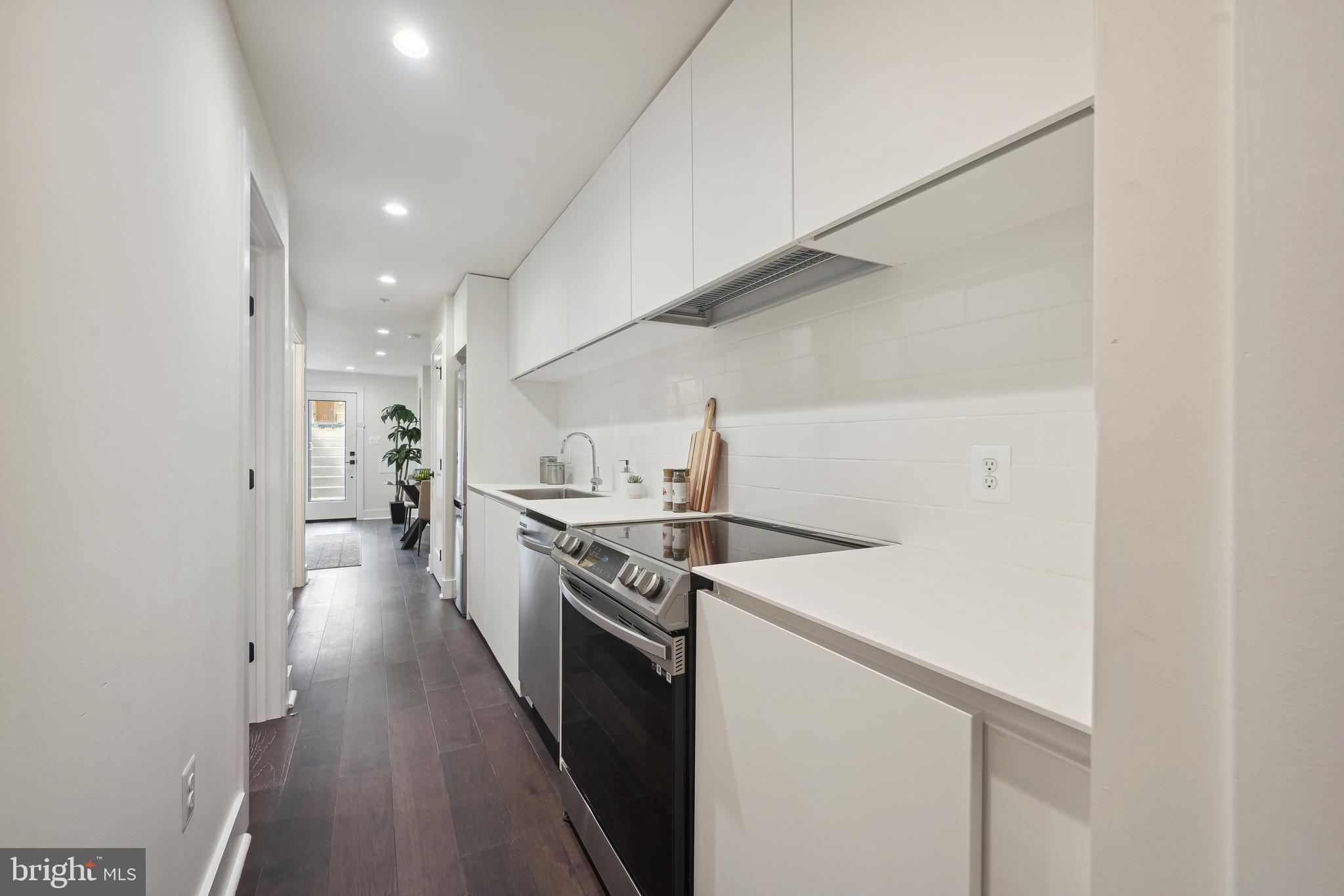 3657 13th Street Northwest Washington, DC 20010 - Photo 26 of 35 a kitchen with a stove and a refrigerator