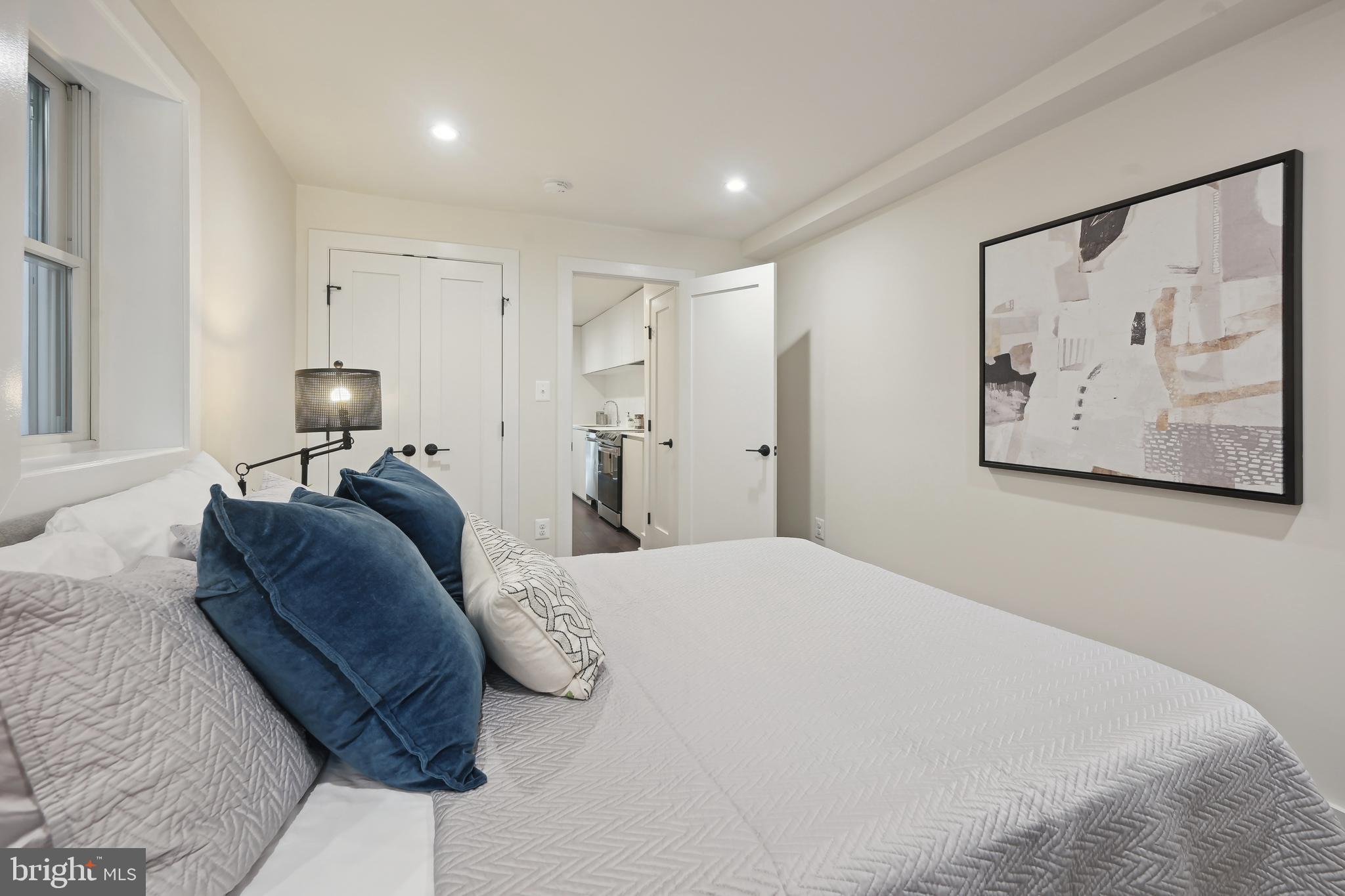 3657 13th Street Northwest Washington, DC 20010 - Photo 29 of 35 a bedroom with a bed and painting on the wall