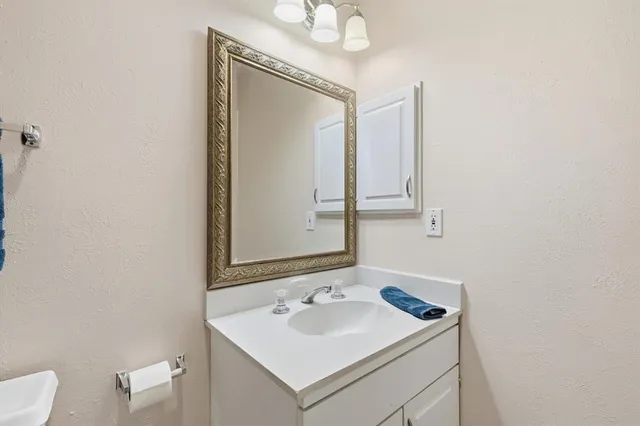 a bathroom with a sink toilet and mirror