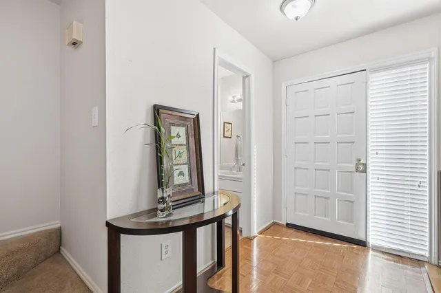 a view of a livingroom with a table and chairs