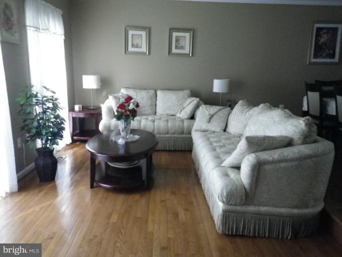 8222 Maple Ridge Avenue Springfield, VA 22153 - Photo 12 of 15 a living room with furniture and a potted plant
