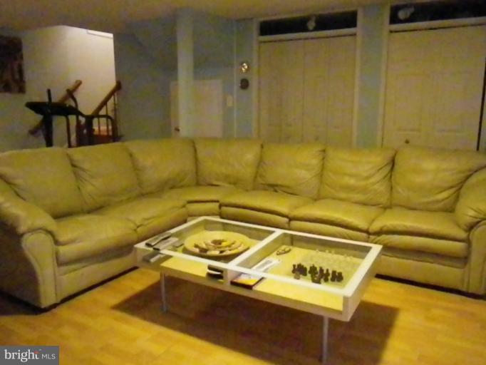 8222 Maple Ridge Avenue Springfield, VA 22153 - Photo 13 of 15 a living room with a couch and a dining table