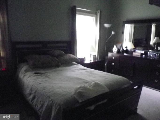 8222 Maple Ridge Avenue Springfield, VA 22153 - Photo 14 of 15 a bedroom with a bed and a mirror