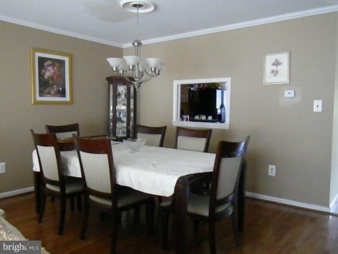 8222 Maple Ridge Avenue Springfield, VA 22153 - Photo 4 of 15 a view of a dining room with furniture wooden floor and a chandelier
