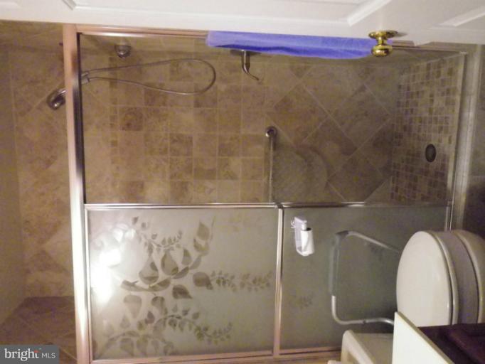 8222 Maple Ridge Avenue Springfield, VA 22153 - Photo 9 of 15 a bathroom with a shower and toilet