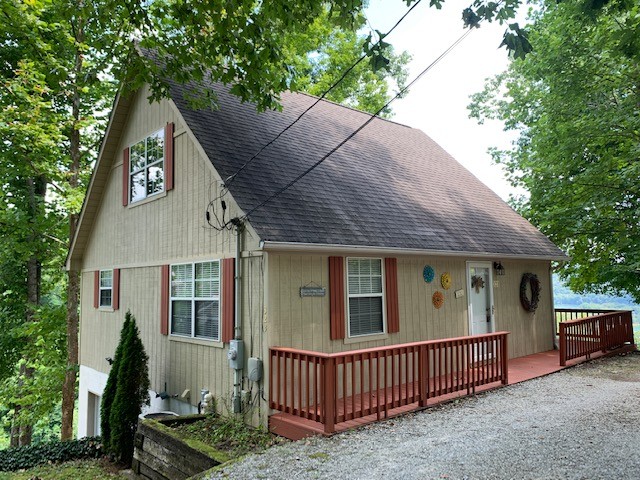 a view of a house with a yard and deck