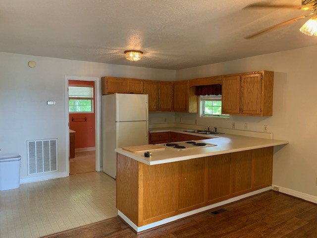 323 Cosby Parris Road Byrdstown, TN 38549 - Photo 4 of 28 a kitchen with a refrigerator sink and wooden cabinets