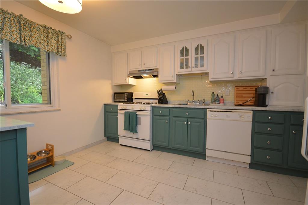 226 Hillendale Road Pittsburgh, PA 15237 - Photo 8 of 25 a kitchen with a sink a stove and cabinets
