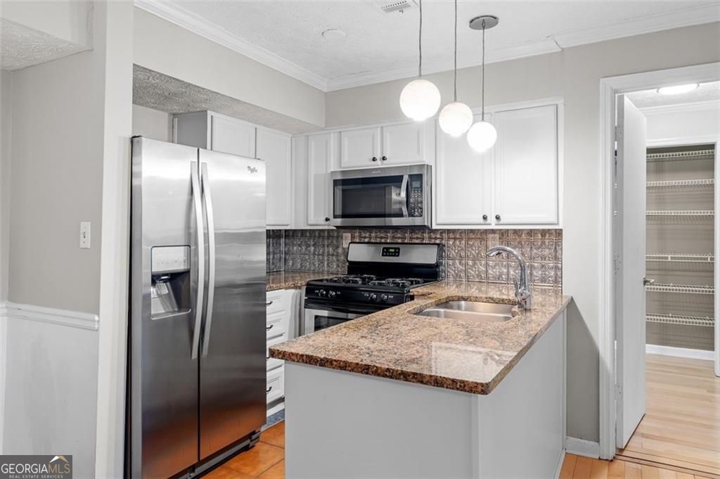 2045 Brian Way Decatur, GA 30033 - Photo 5 of 35 a kitchen with a center island and stainless steel appliances