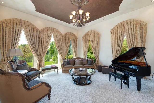 a living room with patio furniture and a large window