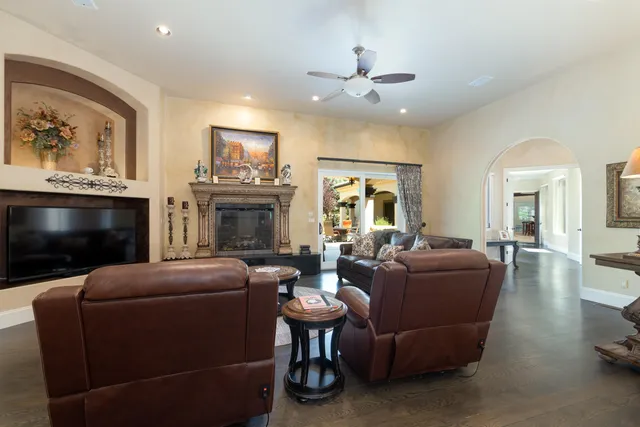 a living room with furniture a fireplace and a flat screen tv