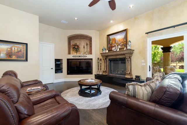 a living room with furniture a fireplace and a flat screen tv