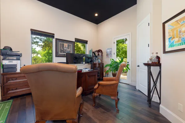 a living room with furniture a potted plant and a flat screen tv