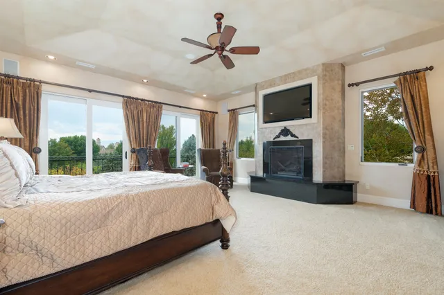 a bed sitting in a room next to a large window