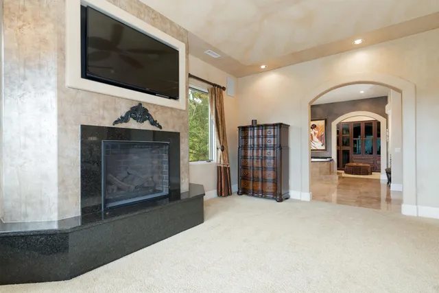 a living room with fireplace furniture and a flat screen tv