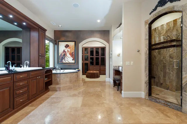 a large spacious bathroom with a large tub and shower