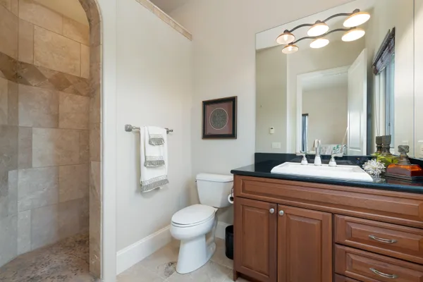 a bathroom with a sink a toilet and mirror