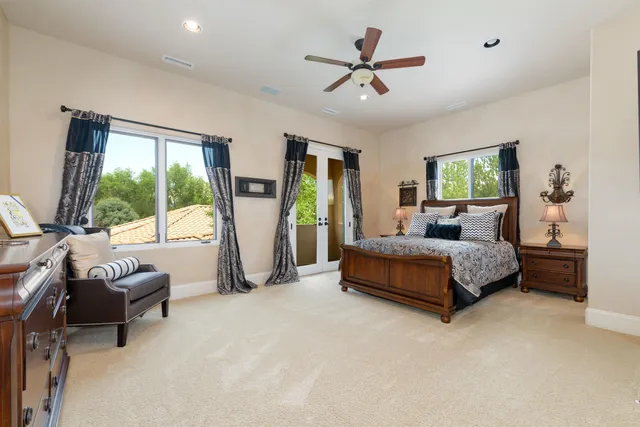 a bedroom with a bed and a chandelier