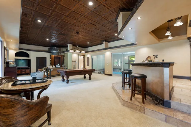 a living room with furniture a flat screen tv and a table