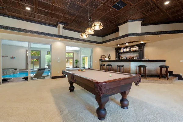 a room with furniture and pool table