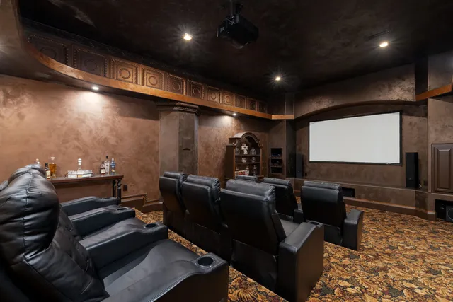 a media room with lots of chairs and a projector screen