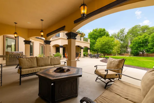 a view of a patio with table and chairs and potted plants