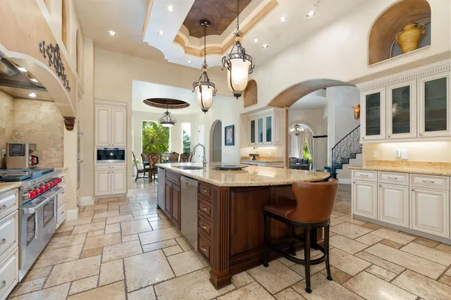 a kitchen with stainless steel appliances a sink stove and cabinets