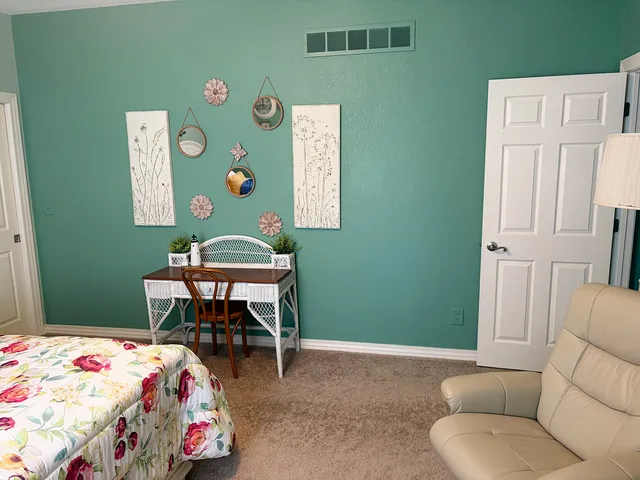 a bedroom with a bed and a table in it