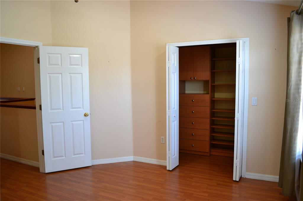 11235 Kapok Grand Circle Madeira Beach, FL 33708 - Photo 20 of 34 an empty room with wooden floor closet and windows