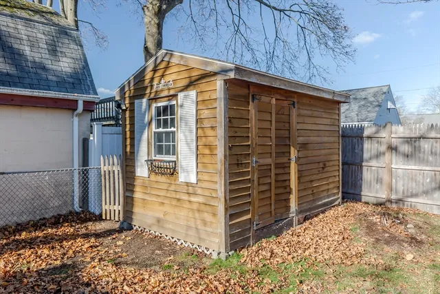 a view of a house with a door and wooden walls