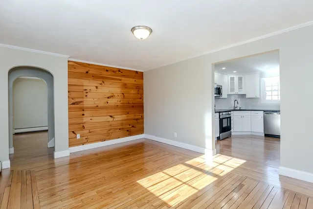 a view of a kitchen with wooden floor and a kitchen