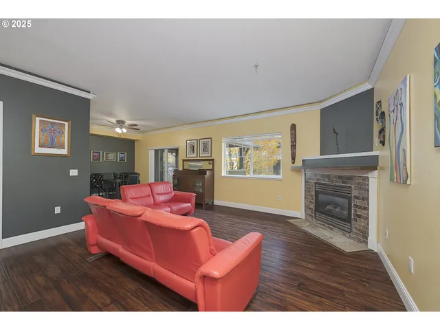 a living room with furniture a fireplace and wooden floor
