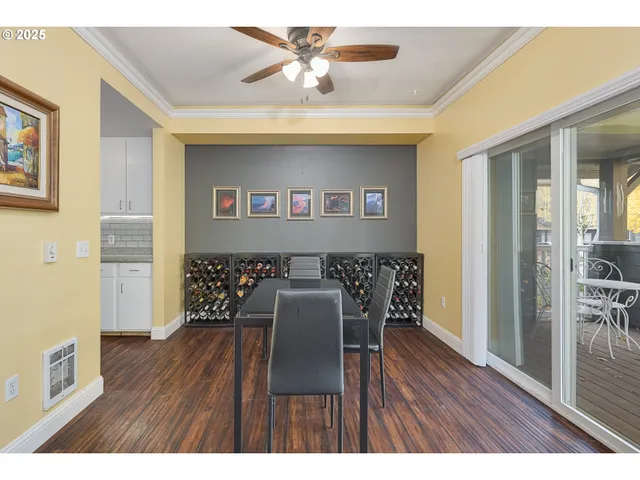 a workspace with furniture wooden floor and a ceiling fan